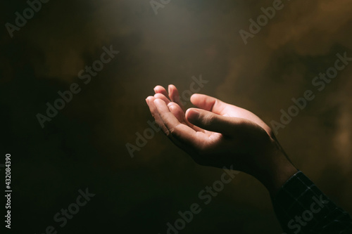 Human hands open palm up worship with faith in religion and belief in God on blessing background.Christian Religion concept background.
