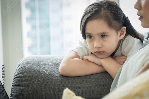 Child showing tantrum or meltdown behavior at the sofa