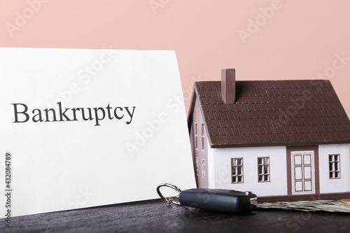 Model of house with car key...