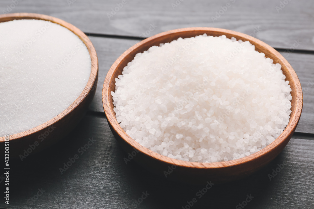 Bowls with different salt on dark wooden background Bowls with different salt on dark wooden background