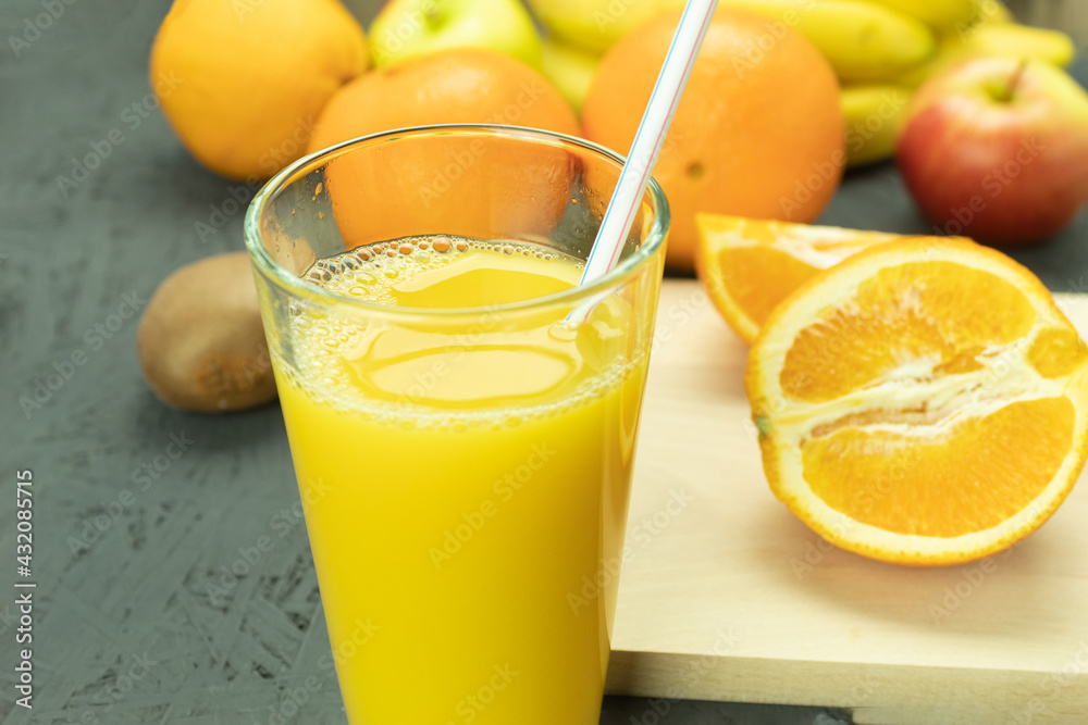 Fresh orange juice in a glass and fresh fruits