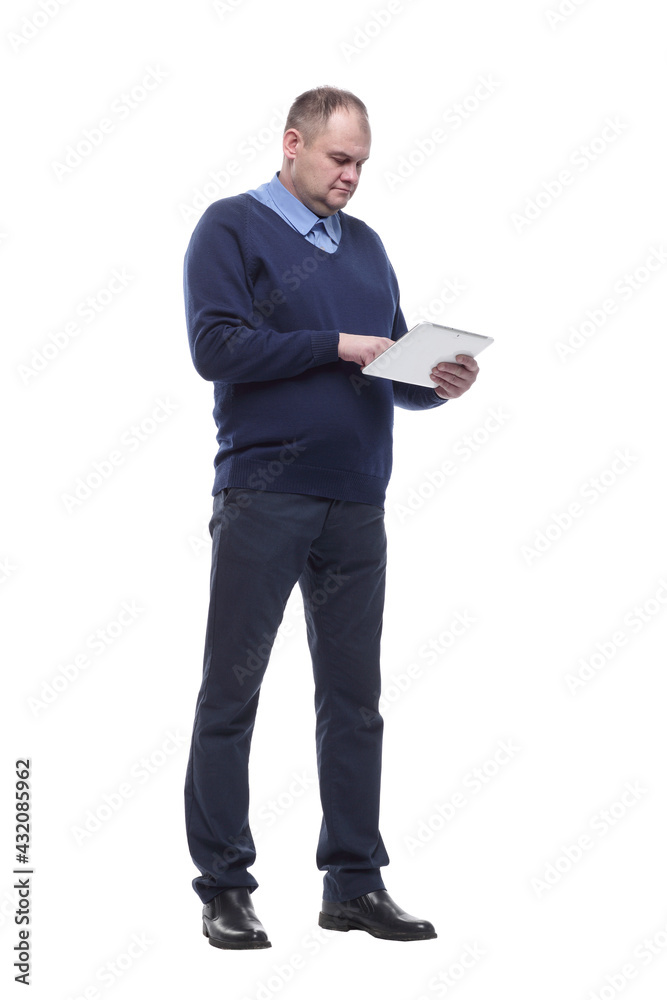 in full growth. serious man with a digital tablet. in full growth. serious man with a digital tablet.