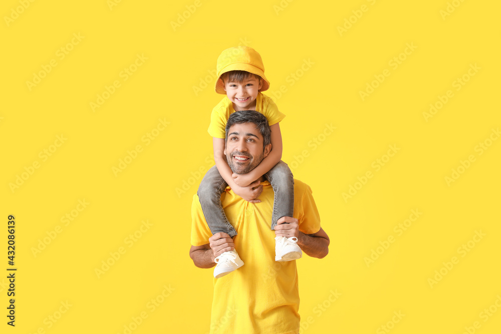 Happy father and his little son on color
