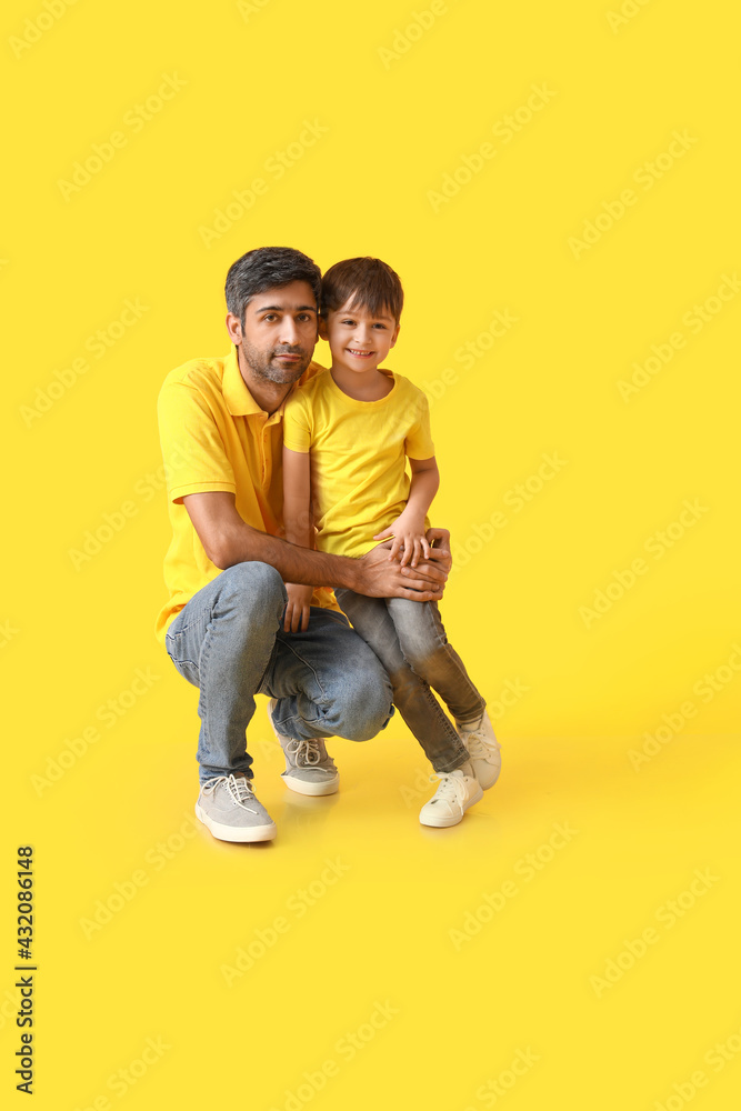 Happy father and his little son on color