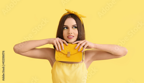 Stylish young woman with ba...