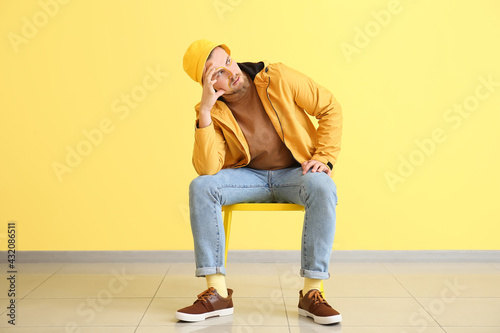 Stylish young man sitting o...