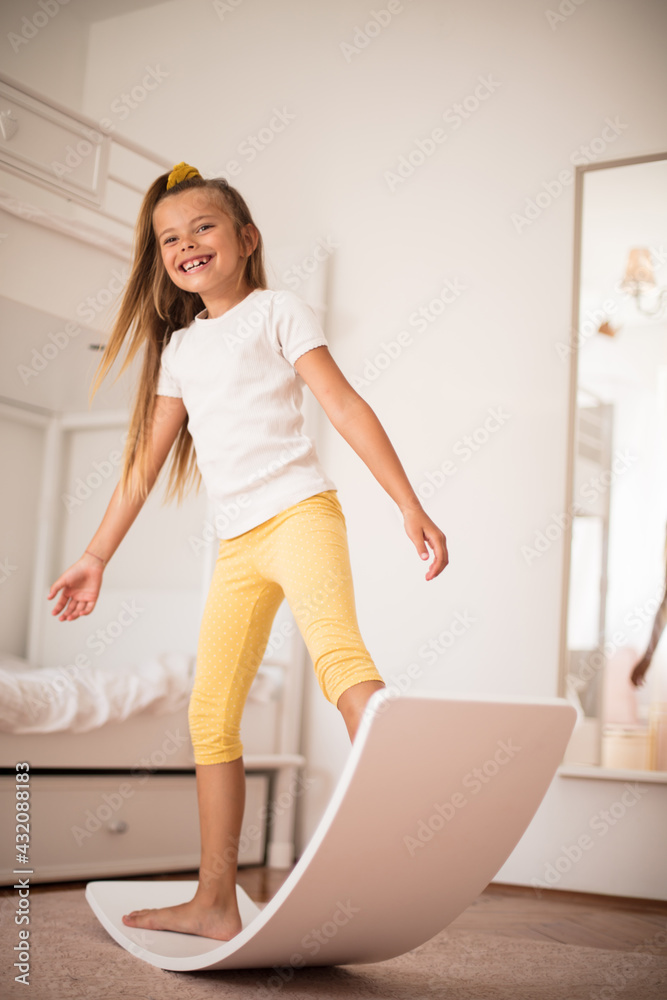 Smiling little girl playing in bedroom alone. Smiling little girl playing in bedroom alone.