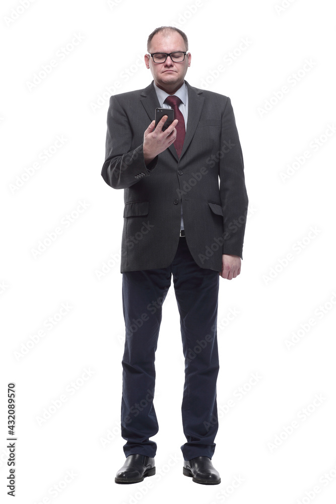 in full growth. serious business man with a smartphone. in full growth. serious business man with a smartphone.