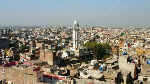 Minaret Of A Mosque With Cityscape At Daytime In Rawalpindi, Pakistan. - aerial approach photo