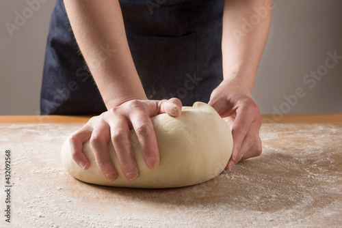 Photos Culinary, cooking, baking concept. Female hands kneading dough