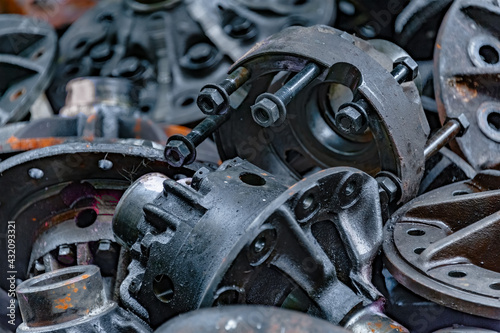 Close-up of old engine parts, piled up for sale in a metal scrapyard.