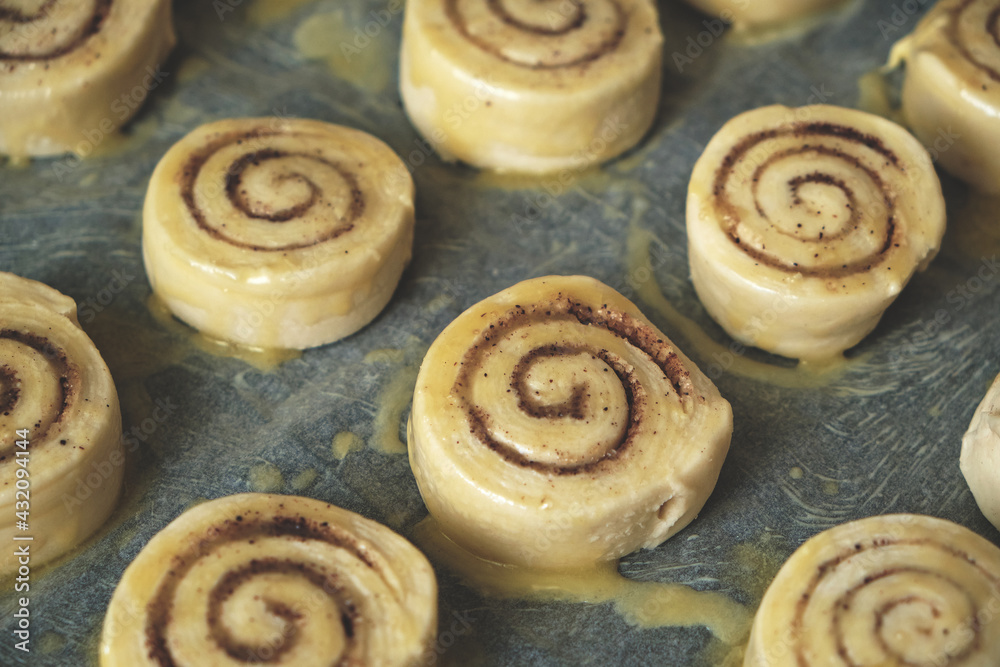 Blanks for baking cinnamon rolls on baking sheet with parchment paper. Blanks for baking cinnamon rolls on baking sheet with parchment paper.