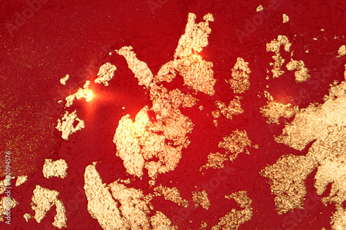Bright red and gold marble texture with sparkles. Abstract vector background in alcohol ink technique. Modern paint with glitter. Template for banner, poster design. Fluid art painting