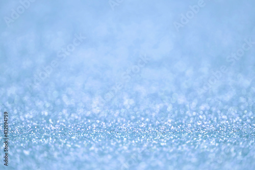Texture of light blue silver glitter dust surface, luxury background with bokeh