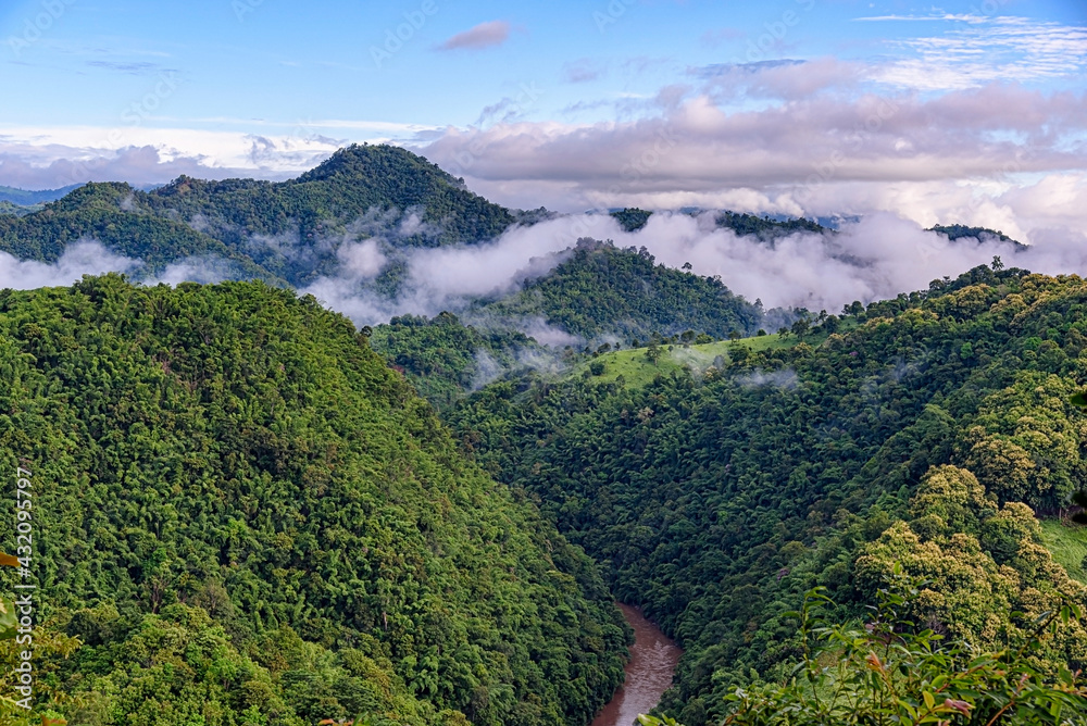 Landscape of mountain river with clouds in southeast Asia tropical green forest.