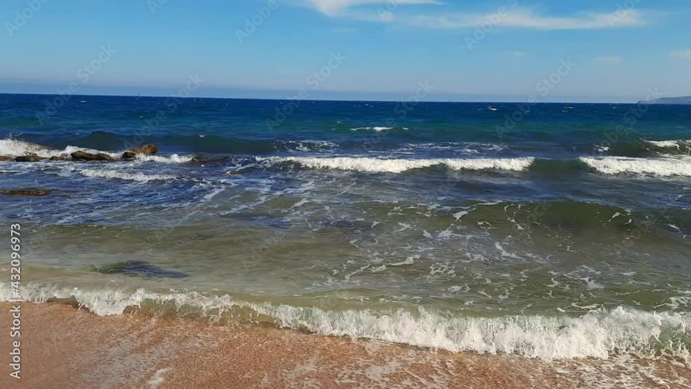 The sea, sea coast, waves roll on the shore on a clear day The sea, sea coast, waves roll on the shore on a clear day