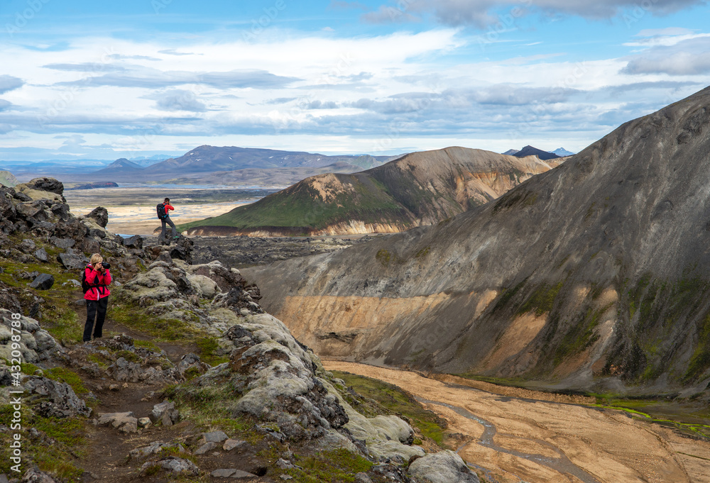 Hikers in volcanic mountains of Landmannalaugar in Fjallabak Nature Reserve. Iceland