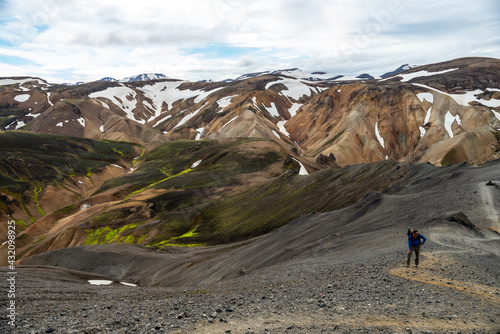 Hikers in volcanic mountains of Landmannalaugar in Fjallabak Nature Reserve. Iceland