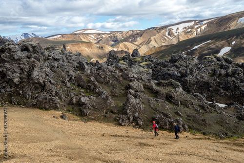 Hikers in volcanic mountains of Landmannalaugar in Fjallabak Nature Reserve. Iceland