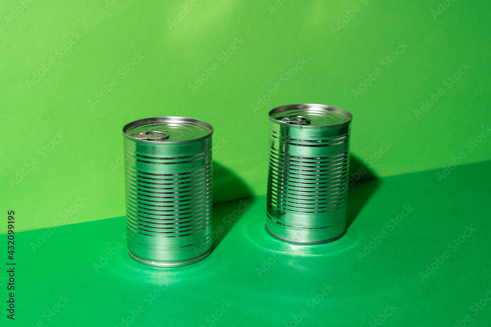 Canned food tin on green studio background Canned food tin on green studio background