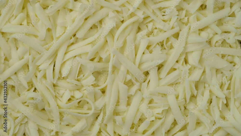 grated mozzarella cheese top view. Sliding shot. pizza grated mozzarella cheese. 4K UHD video grated mozzarella cheese top view. Sliding shot. pizza grated mozzarella cheese. 4K UHD video
