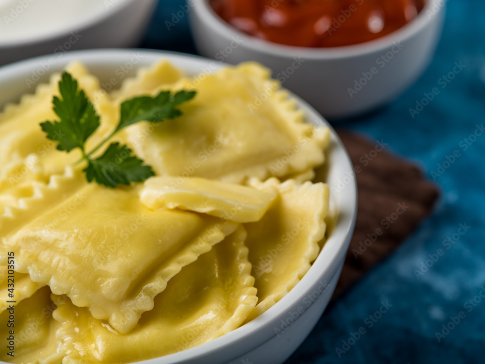 Ready homemade ravioli or dumplings with sauces Delicious homemade food
