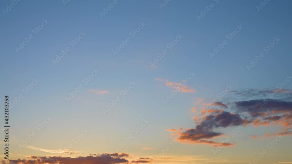Video time lapse of beautiful peaceful cloudy sunset clear blue heaven. White and orange sunny soft clouds moving slowly in evening golden sky. Panoramic natural background Video time lapse of beautiful peaceful cloudy sunset clear blue heaven. White and orange sunny soft clouds moving slowly in evening golden sky. Panoramic natural background