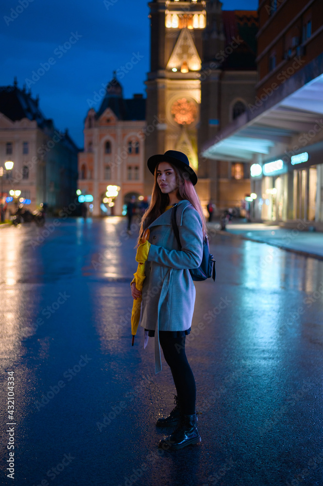 Young beautiful woman holding a yellow umbrella