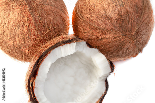 Tropical fruits. Two coconuts and half a coconut close-up on an isolated background. Healthy food concept.