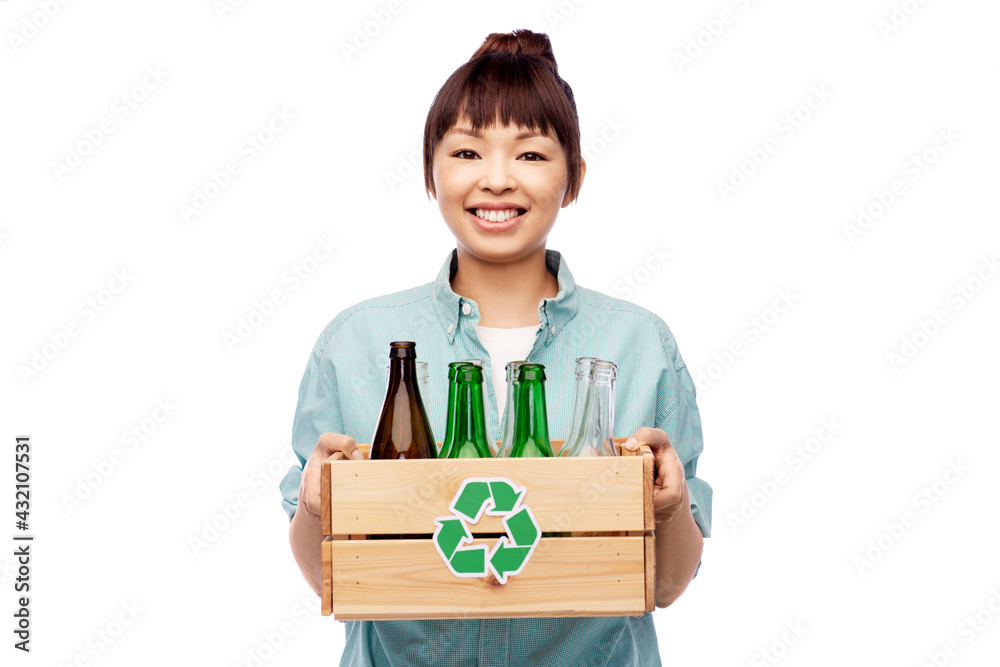 recycling, waste sorting and sustainability concept - smiling young asian woman holding wooden box with glass bottles and jars over white background recycling, waste sorting and sustainability concept - smiling young asian woman holding wooden box with glass bottles and jars over white background
