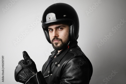 Bearded biker man, posing on the white background wearing black helmet. © face_reader_img
