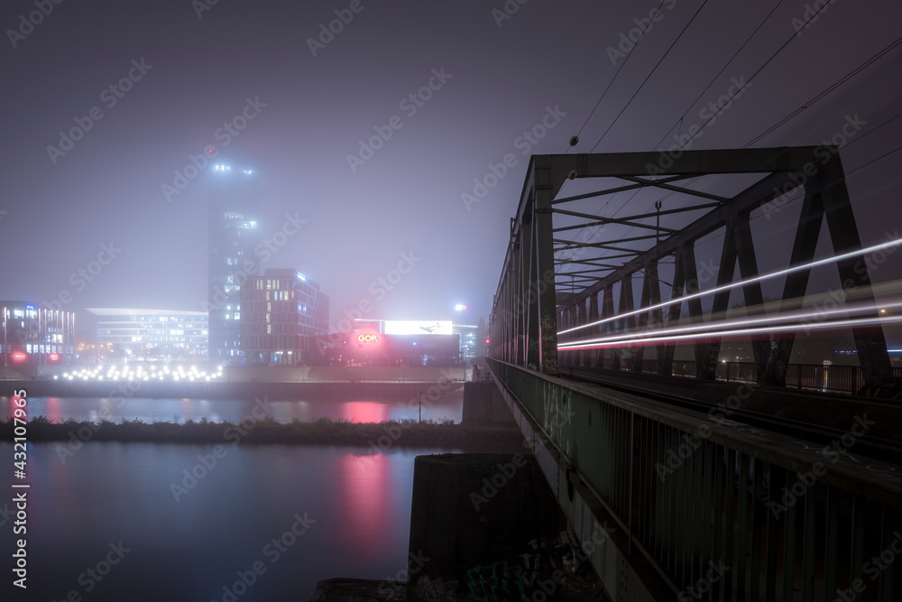 Train bridge at a foggy night with light trail Train bridge at a foggy night with light trail