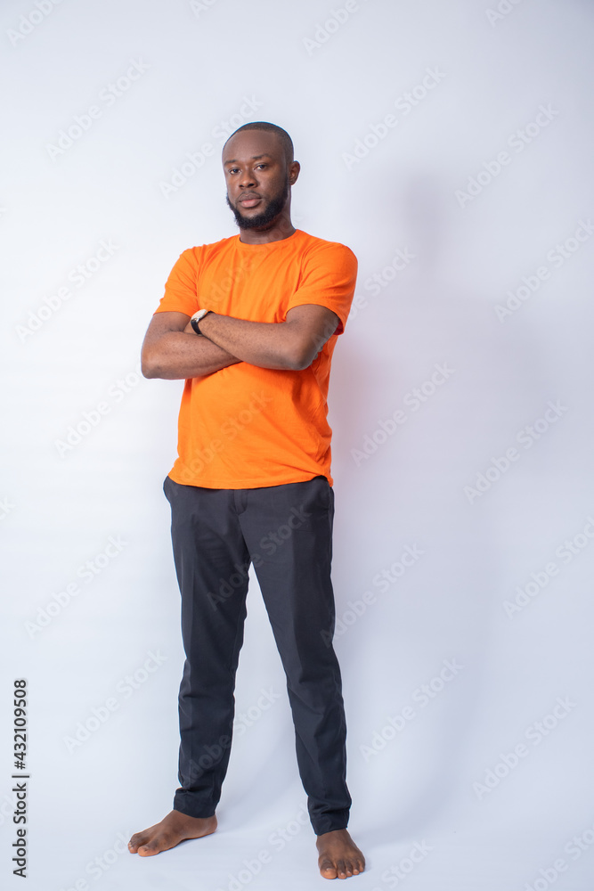 portrait of a young black man standing against a white background portrait of a young black man standing against a white background