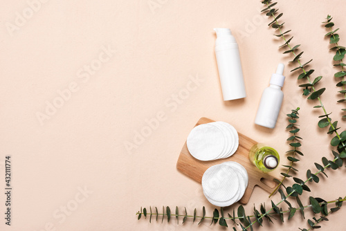 Bottles of essence or serum with natural eucalyptus leaves