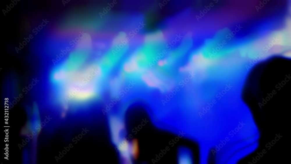 Blurred silhouettes of people dancing at party in a nightclub. Music concert with motion dances and party neon flickering lights. Have fun tonight. Holidays entertainment. Blurred silhouettes of people dancing at party in a nightclub. Music concert with motion dances and party neon flickering lights. Have fun tonight. Holidays entertainment.
