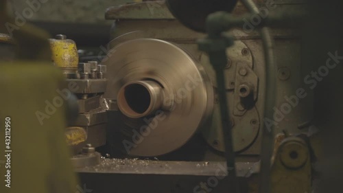 A lathe cuts metal, close-up. Old lathe with an iron billet, working process.