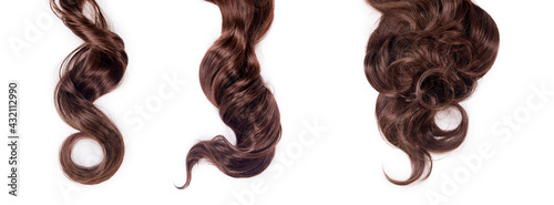 Curly brown hair isolated on white background. Beautiful healthy long chocolate brown hair locks, haircut, hairstyle. Dyed hair or coloring, hair extension, cure, treatment concept. Banner photo