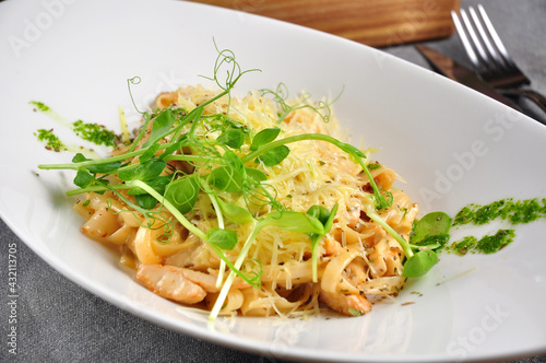 pasta with chicken and bacon on a white plate