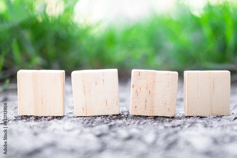 Square wooden on floor cement with blur image of grass green background ...