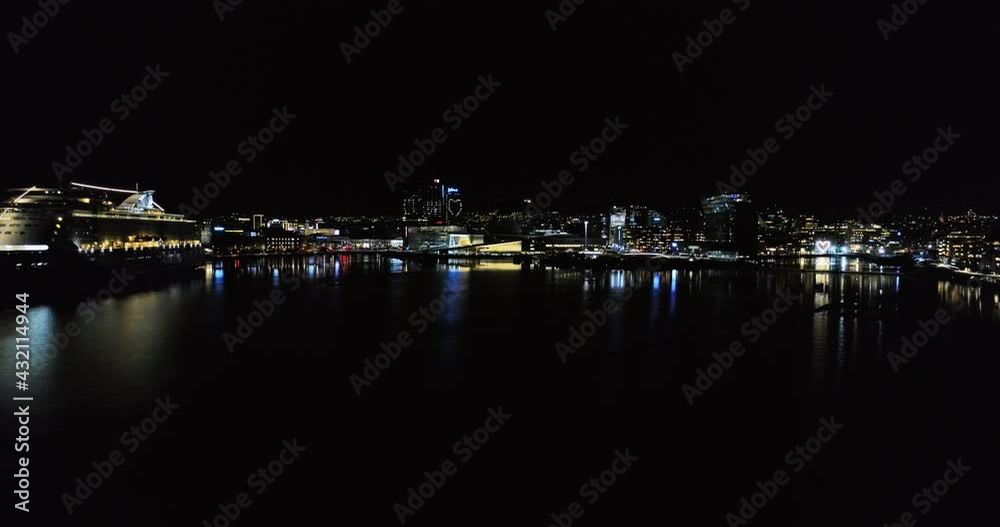 Aerial panorama view from illuminated Opera House by fjord to downtown city Aerial panorama view from illuminated Opera House by fjord to downtown city