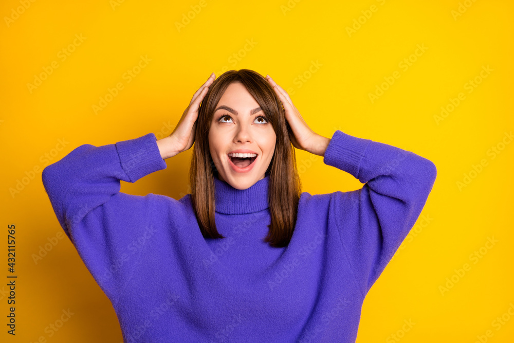 Portrait of attractive girlish amazed cheerful girl looking up good news isolated over bright yellow color background Portrait of attractive girlish amazed cheerful girl looking up good news isolated over bright yellow color background