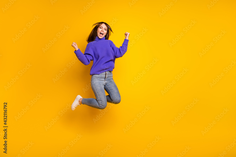 Full length body size view of attractive cheerful lucky girl jumping having fun rejoicing isolated over bright yellow color background