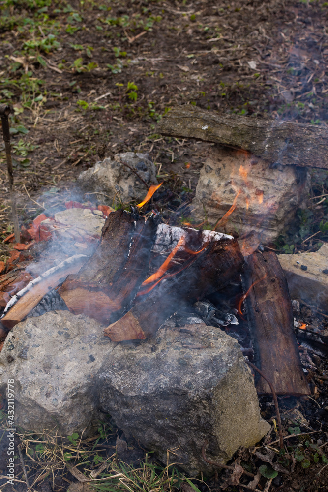 Rest in the garden in nature, preparing a fire for making a barbecue, fire from cherry wood Rest in the garden in nature, preparing a fire for making a barbecue, fire from cherry wood
