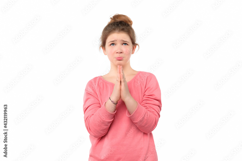 Sad pleading teen girl keeps hands pressed together asks for apologize, has innocent expression. Please give me chance Sad pleading teen girl keeps hands pressed together asks for apologize, has innocent expression. Please give me chance