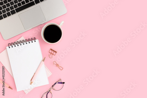Workplace for e-learning with laptop and coffee on a pink background. Online education, distance work concept with place for text.
