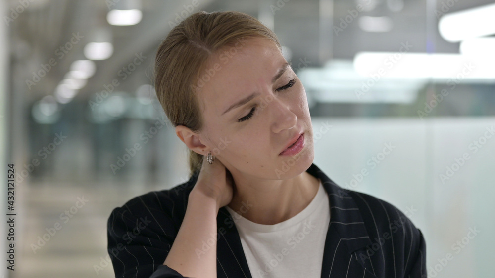 Tired Young Businesswoman having Neck Pain