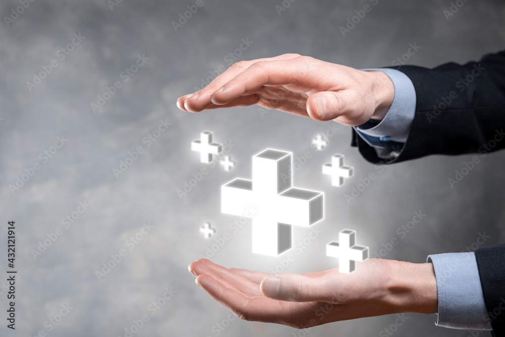 Businessman hold 3D plus icon, man hold in hand offer positive thing such as profit, benefits, development, CSR represented by plus sign.The hand shows the plus sign Businessman hold 3D plus icon, man hold in hand offer positive thing such as profit, benefits, development, CSR represented by plus sign.The hand shows the plus sign