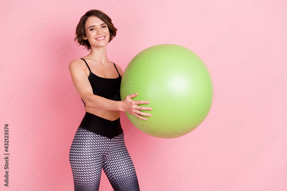 Profile side photo of young sportive girl happy positive make exercises fitball dynamic training isolated over pink color background