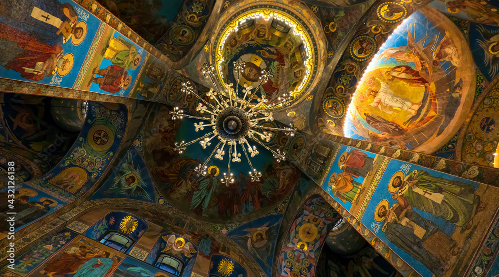 Interior of the Cathedral of the Savior on Spilled Blood. Saint-Petersburg. Russia. Colored frescoes on the vaults of the ceiling. There is a chandelier. Background.