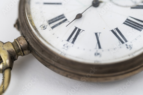 Close up view of pocket watch on white background